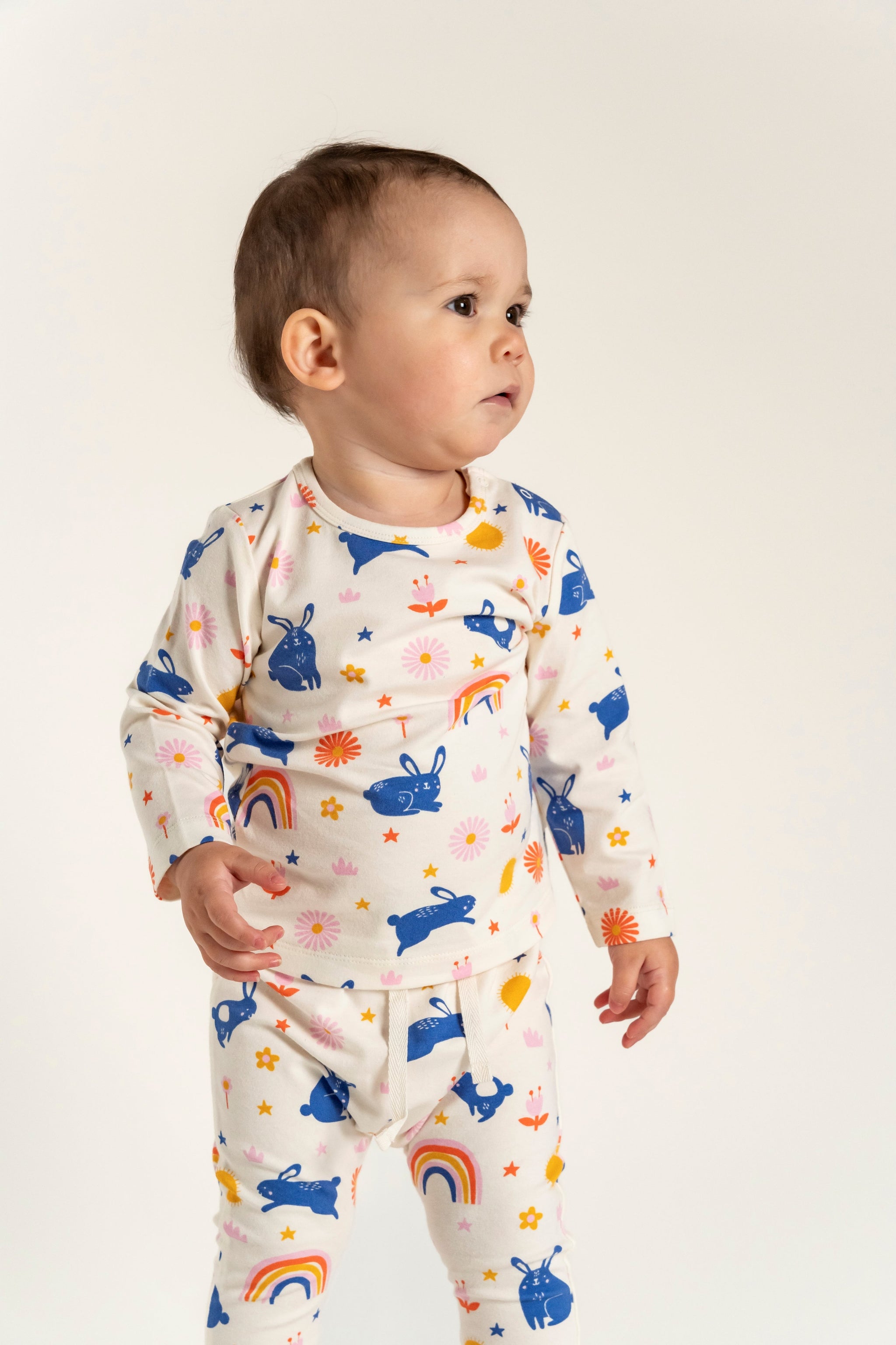 Toddler Girl Slouchy Pants - Bunnies and Rainbow Print, featuring playful blue bunnies, rainbows, and flowers on soft, comfortable fabric, ideal for everyday wear.