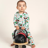 Adorable toddler boy wearing a long sleeve T-shirt and slouchy pants set with a vibrant forest animals print, sitting on a ladybug ride-on toy, perfect for a fun and cozy everyday outfit.