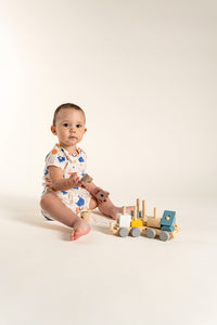 Toddler girl wearing a short sleeve T-shirt and slouchy shorts set in a charming Bunnies and Rainbow print, featuring colorful bunnies, rainbows, and flowers. Perfect for playtime and everyday wear.