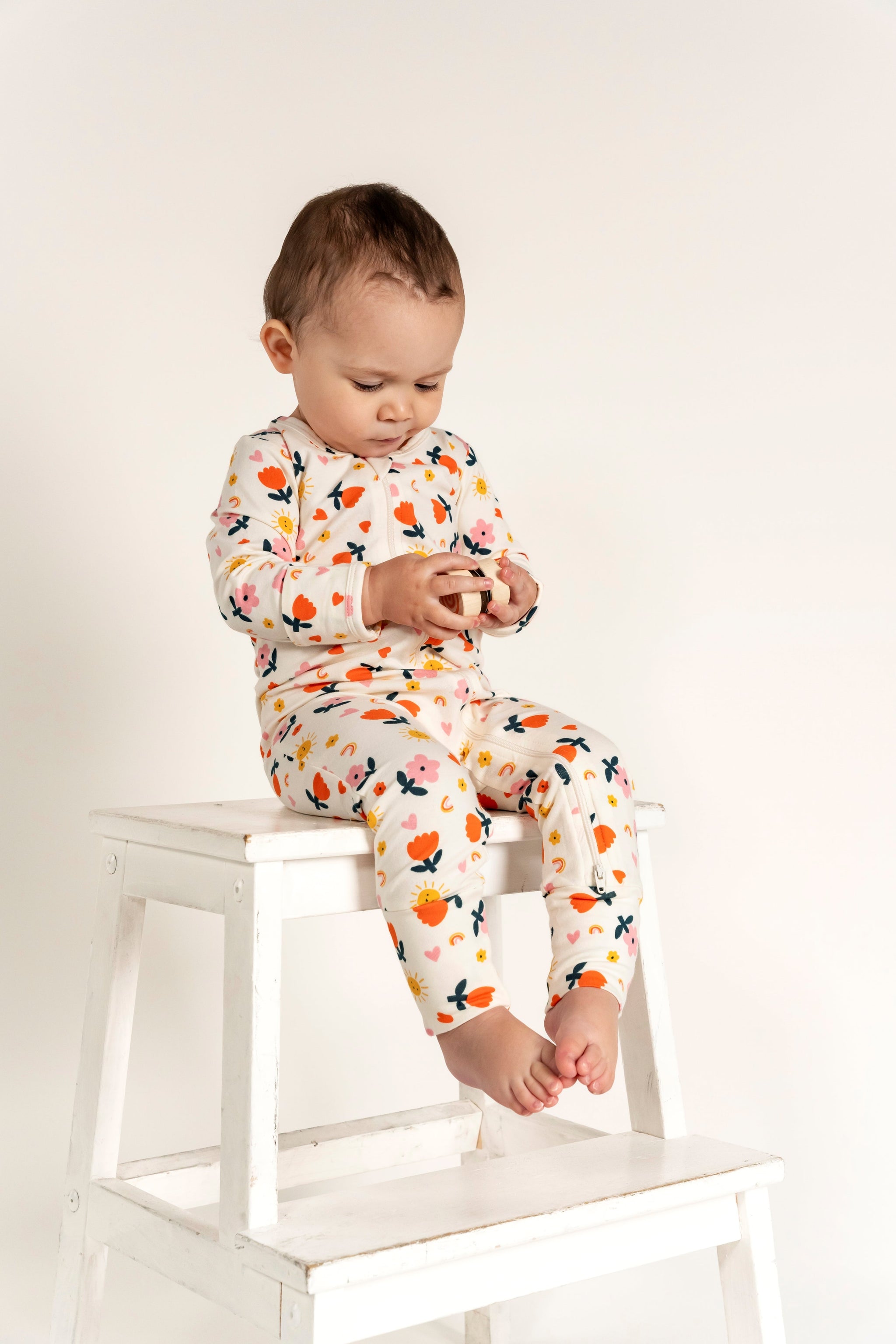 Toddler Girl Long Sleeve Zip Growsuit featuring a cute Sunny Flower Print. Made from soft, breathable fabric with an easy front zipper for quick changes. Perfect for cozy comfort and everyday play.