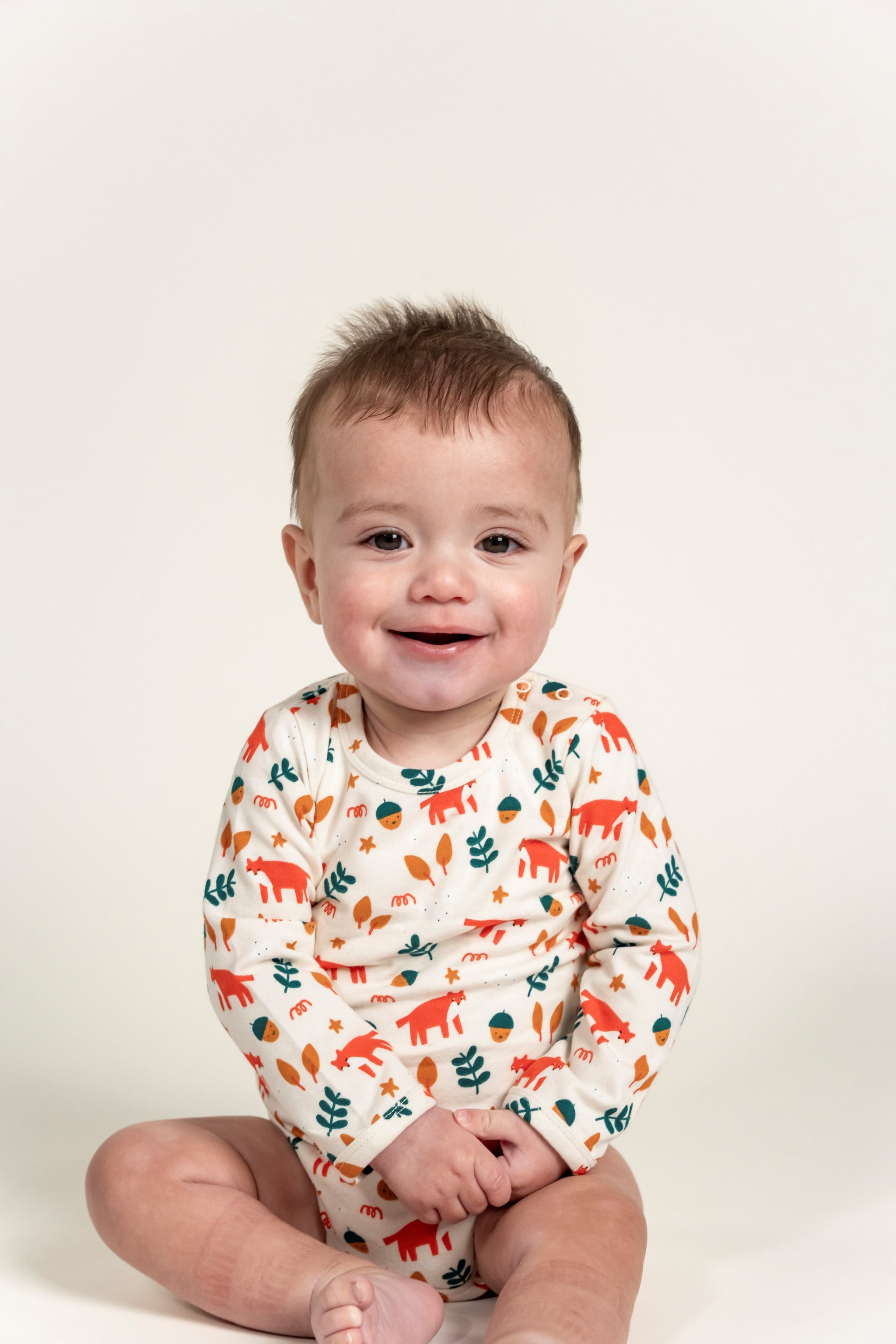 Adorable Toddler Boy Long Sleeve Bodysuit in Fox Forest Print featuring playful foxes, acorns, and leaves. Soft, comfortable fabric perfect for all-day wear, ideal for active toddlers.