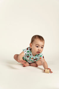 Active toddler boy playing while wearing a short sleeve t-shirt with forest animal print featuring bears, foxes, and trees. Soft, breathable fabric perfect for playtime and everyday comfort.