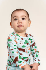 Toddler boy wearing a long sleeve T-shirt featuring a Forest Animal Print with playful woodland creatures like bears, foxes, and trees on a soft blue background. Ideal for outdoor and casual wear.