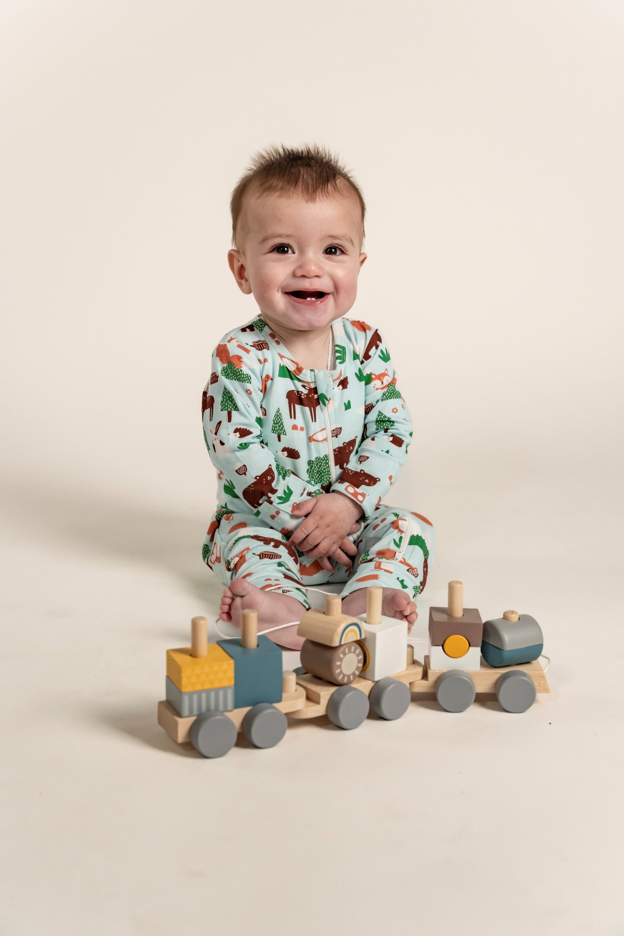 Adorable Toddler Boy Long Sleeve Zip Growsuit in a playful Forest Animal Print featuring bears, foxes, and trees on a light green background. Perfect for cozy comfort and all-day playtime. Shop now!