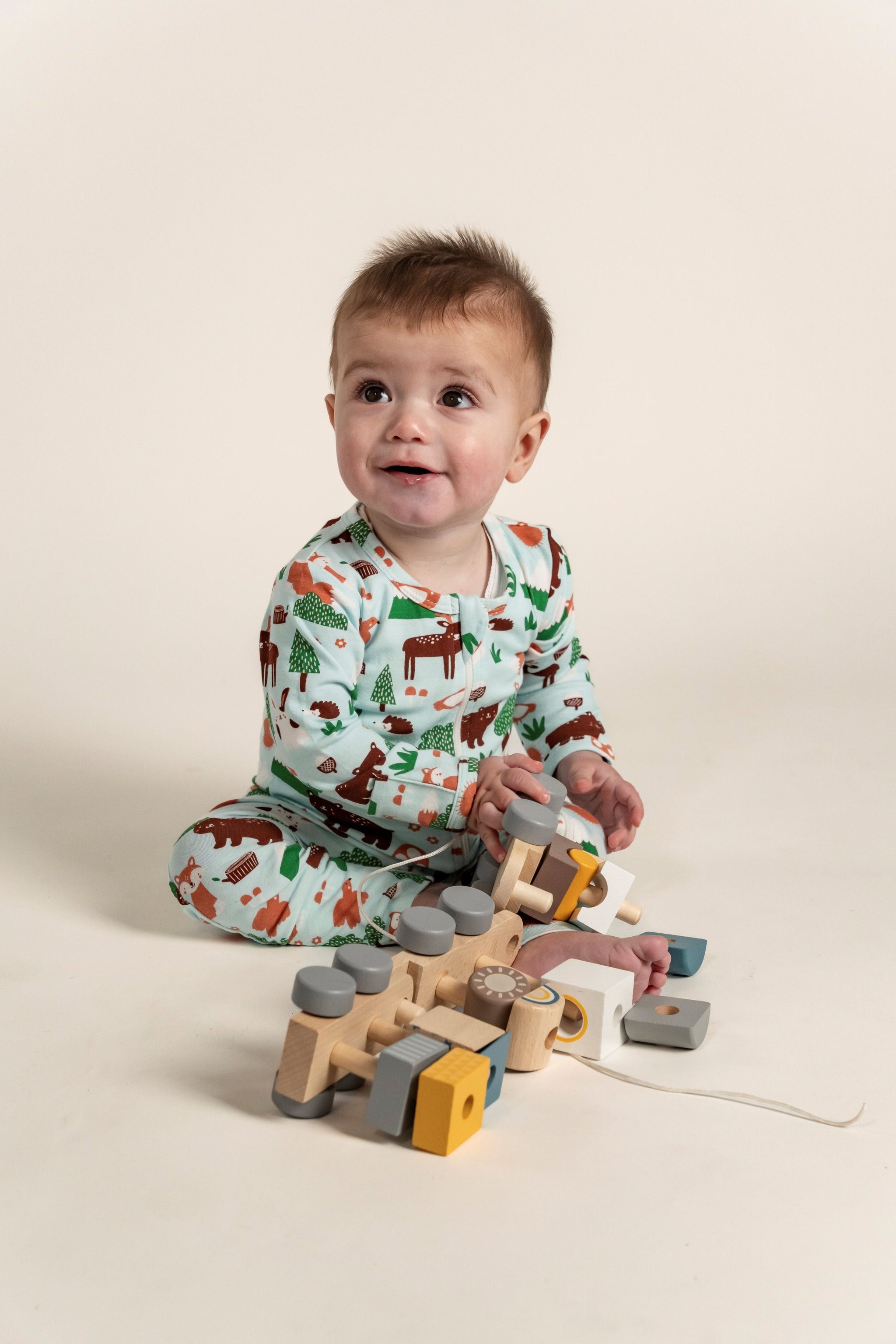 Toddler Boy Long Sleeve Zip Growsuit in a playful Forest Animal Print featuring bears, foxes, and trees on a soft green background. Perfect for cozy comfort and playtime. Shop now for cute toddler outfits!