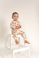 Toddler Girl Long Sleeve Zip Growsuit in a cheerful Sunny Flower Print, made from soft, breathable fabric. Features a front zipper for easy diaper changes. Perfect for cozy comfort and playful adventures.