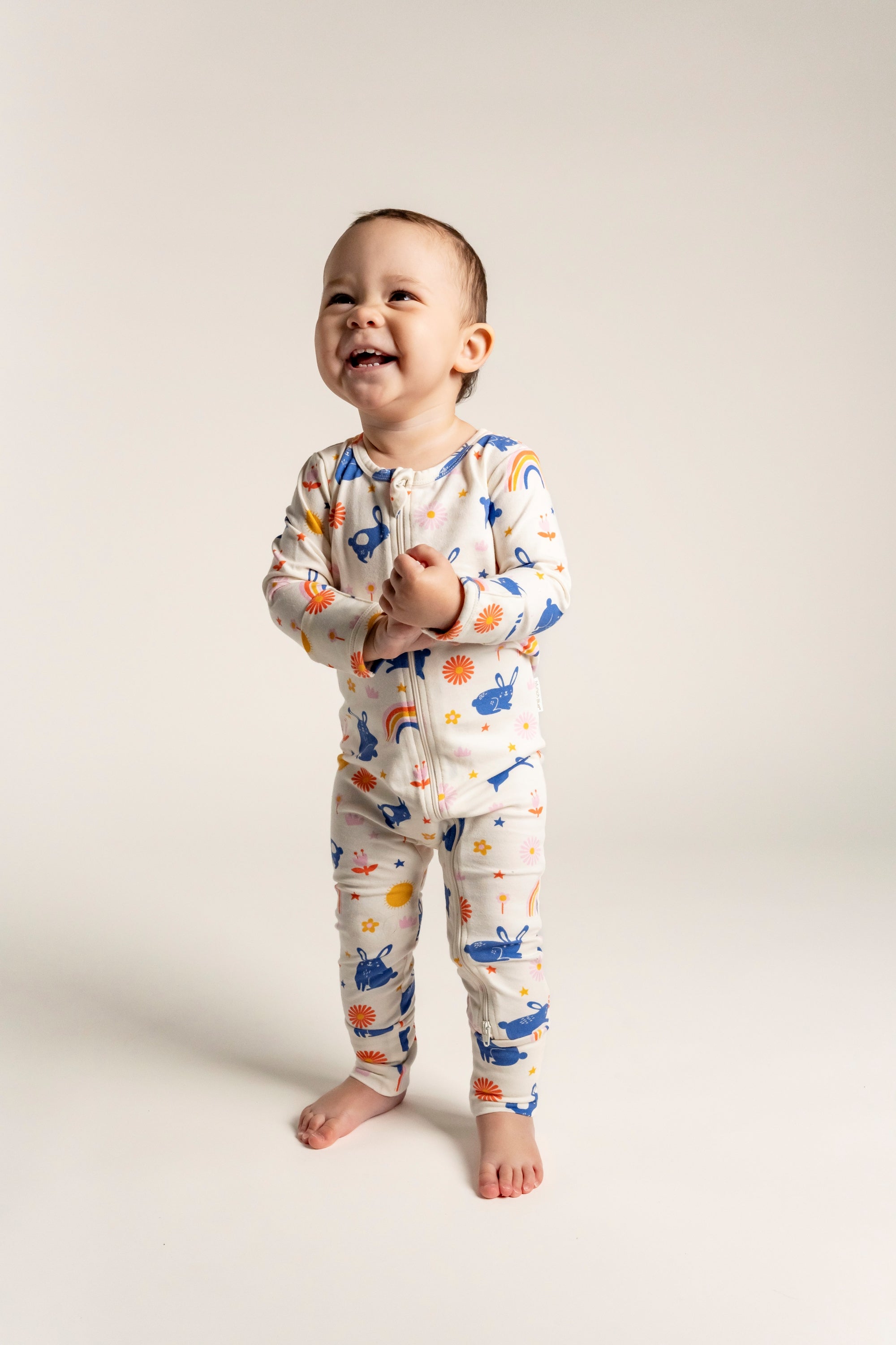 Adorable Toddler Girl Long Sleeve Zip Growsuit with colorful Bunnies and Rainbow Print. Made from soft, breathable fabric, featuring a front zipper for easy changes. Perfect for playful and active toddlers!