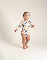 Toddler Girl Long Sleeve Bodysuit - Bunnies and Rainbow Print featuring playful blue bunnies, rainbows, and colorful flowers. Soft and comfy fabric, perfect for everyday wear and active playtime.